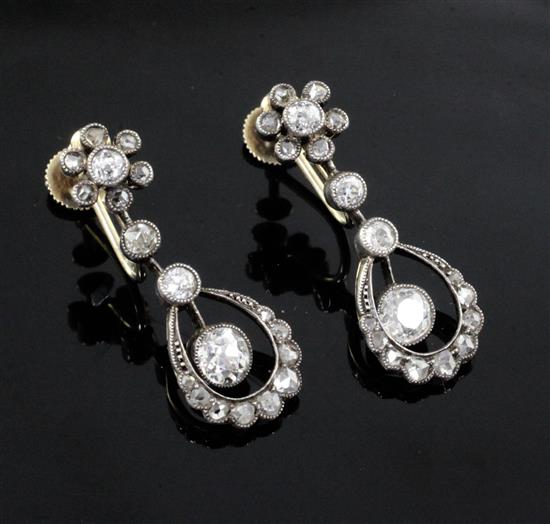 A pair of early 20th century yellow metal and diamond open work drop earclips, 23mm.